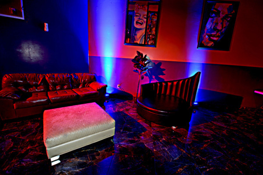 Lounge with hand-shaped chair and red rose artwork
