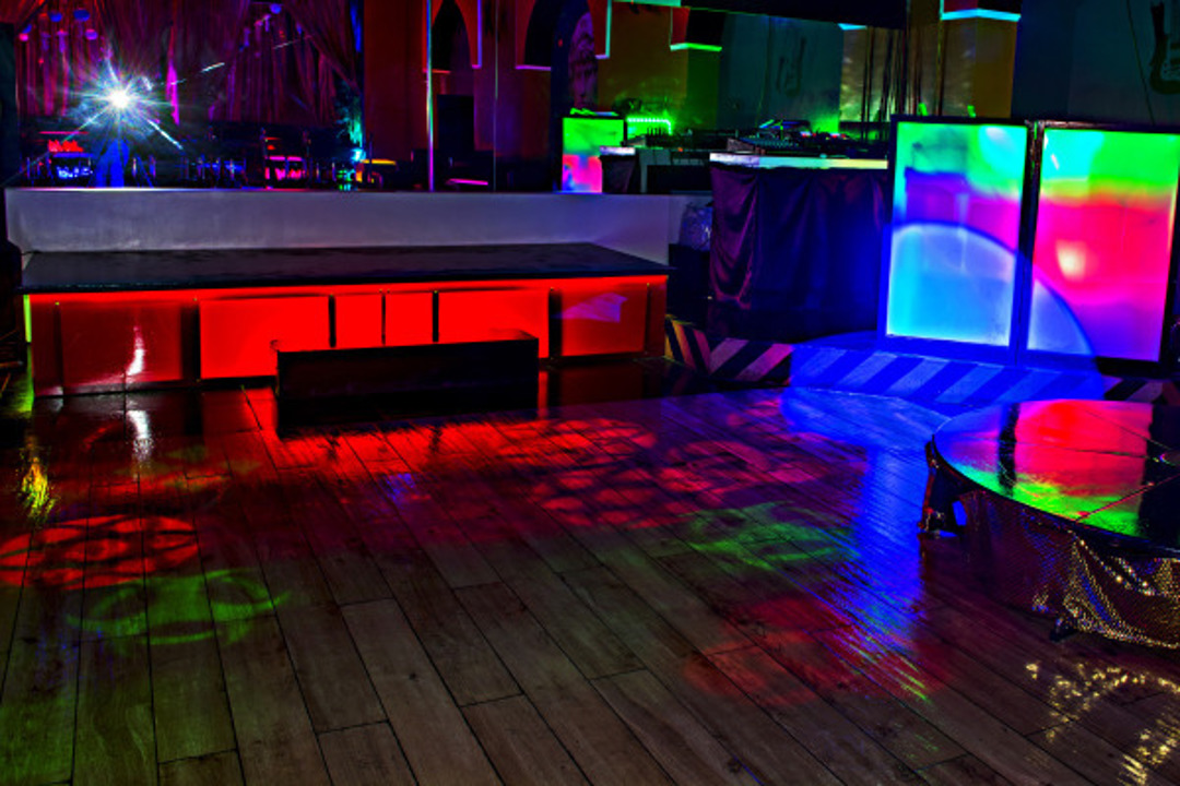 Dance floor with colorful laser lighting and lounge seating