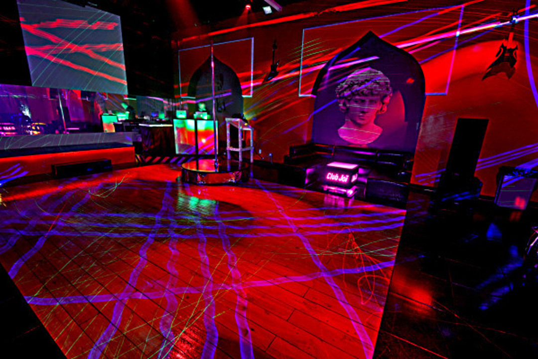 Main dance floor with colorful lighting and decorative statue