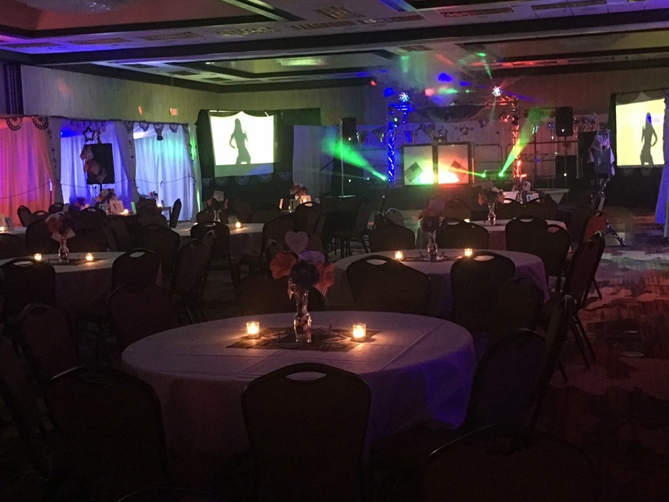 Lifestyle party venue with tables and colorful dance lighting