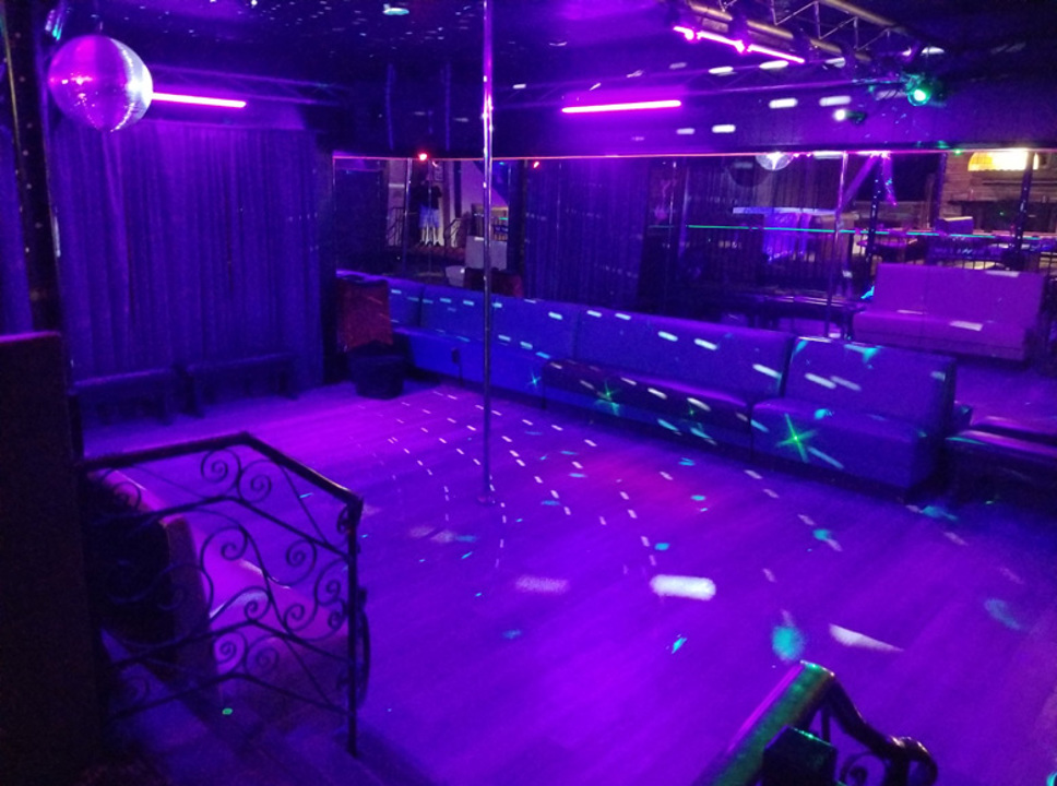 Purple-lit dance floor and lounge