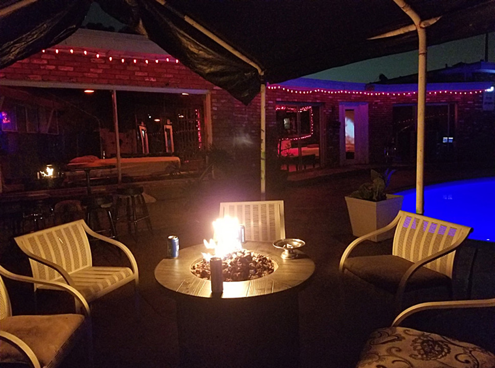 Nighttime pool patio and fire pit
