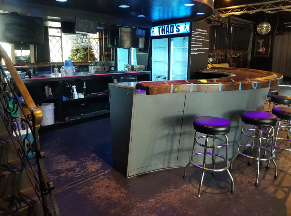 Bar counter and stools inside Thads Private Club