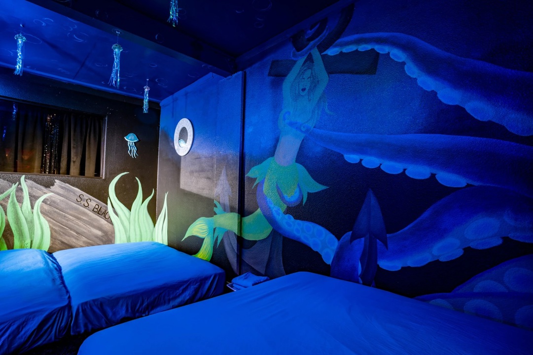 Blue-lit mermaid-themed room