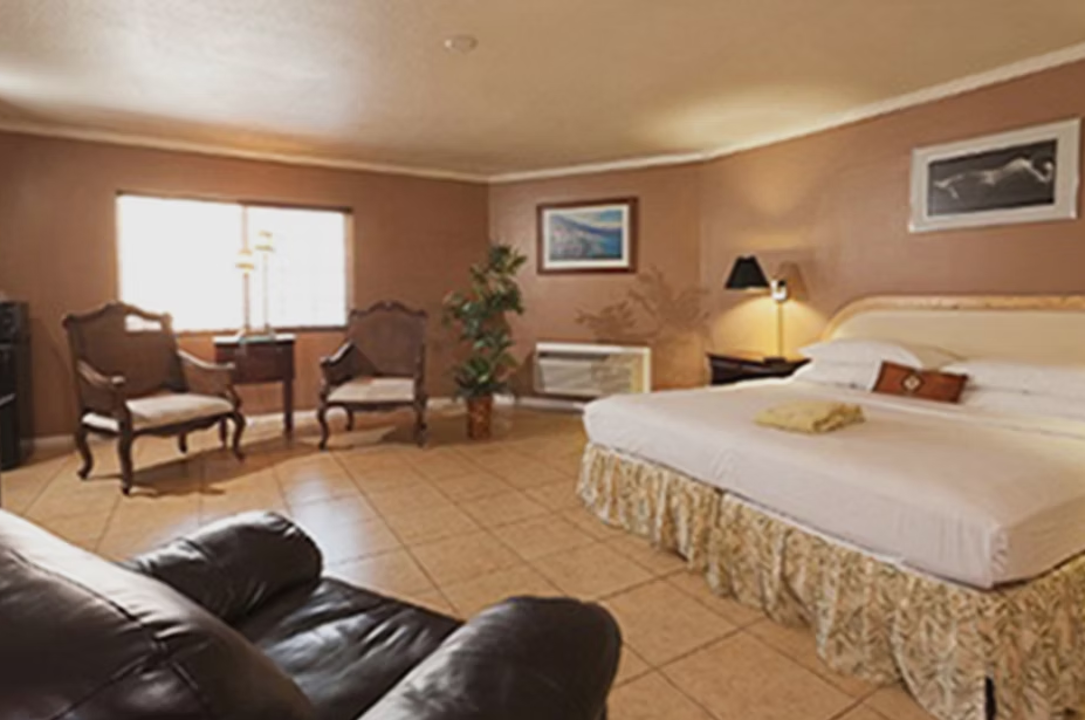 Deluxe guest room with king bed and lounge seating