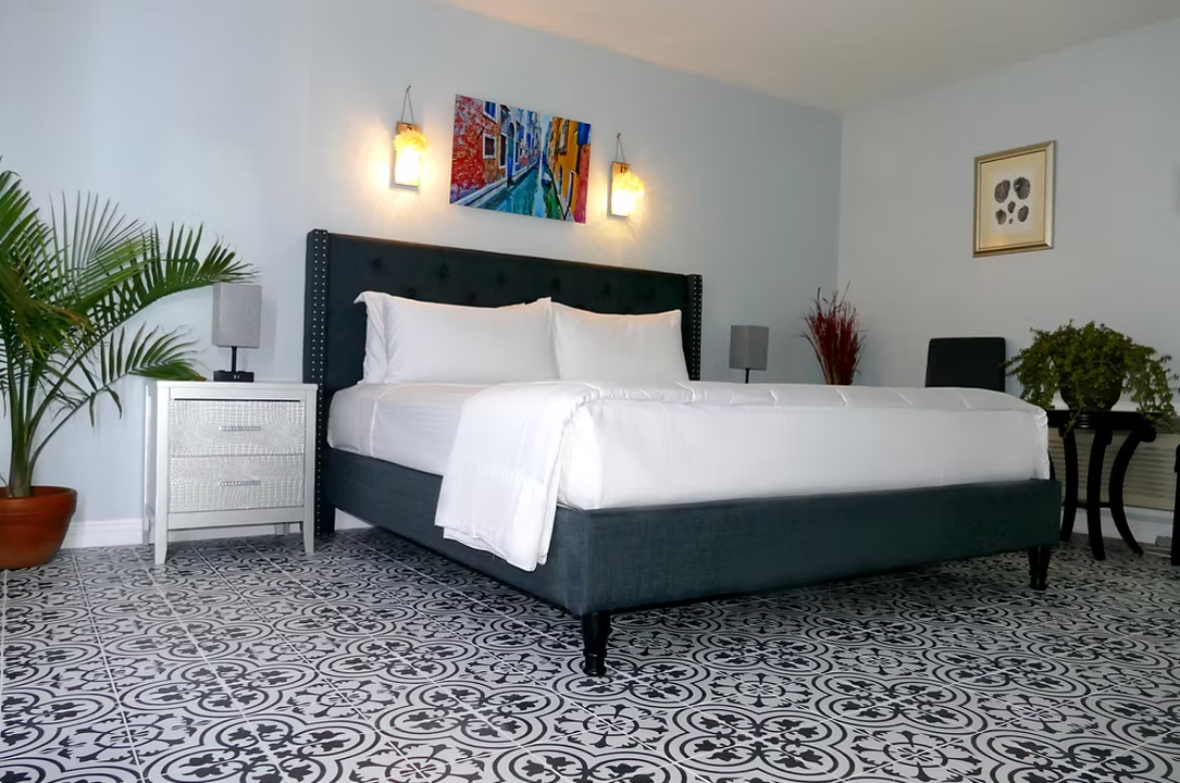 Modern king guest room with patterned tile floor