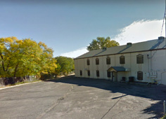 Exterior and parking area of Voodoo Leatherworks in Colorado Springs, Colorado