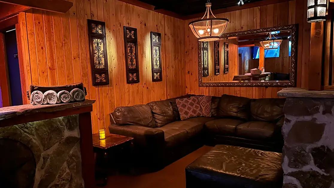 Wood-paneled lounge with leather sectional seating