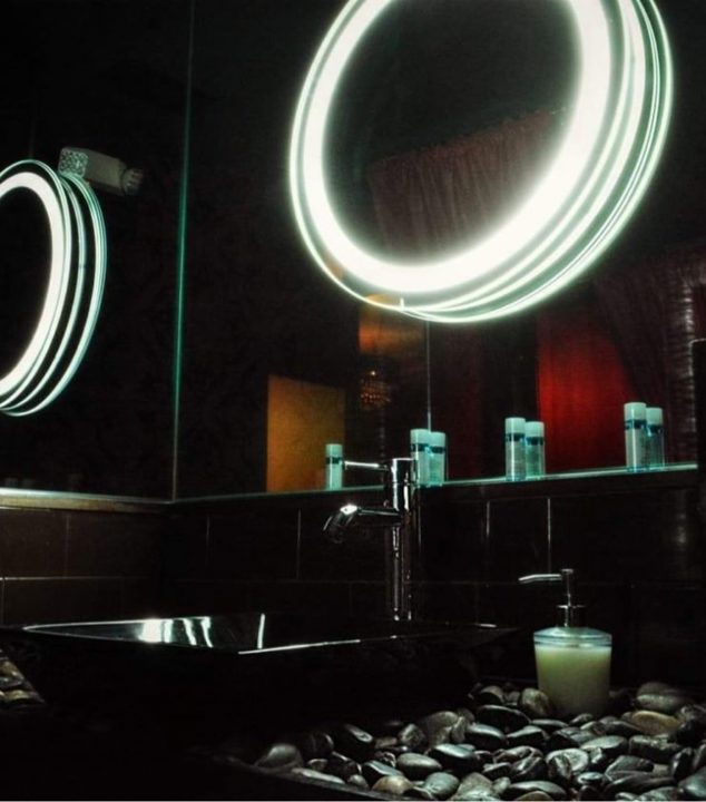 Vanity area with illuminated mirrors