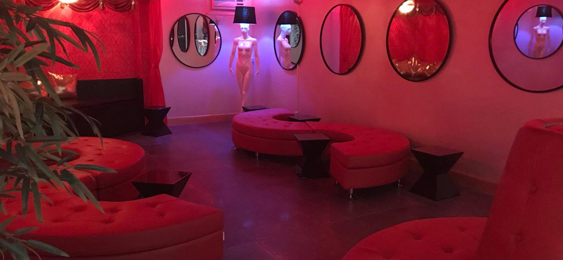 dults-only lounge with red seating and mirrors
