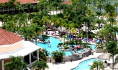 Aerial view of Caliente Club and Resorts in Land O Lakes, Florida, with palm trees, pools and resort buildings