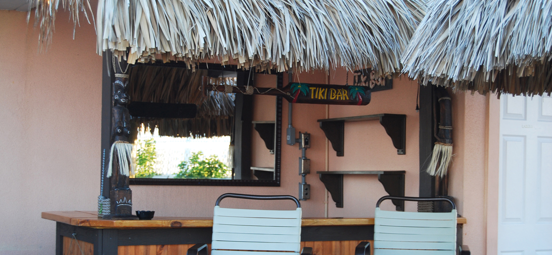 Outdoor tiki bar with thatched roof