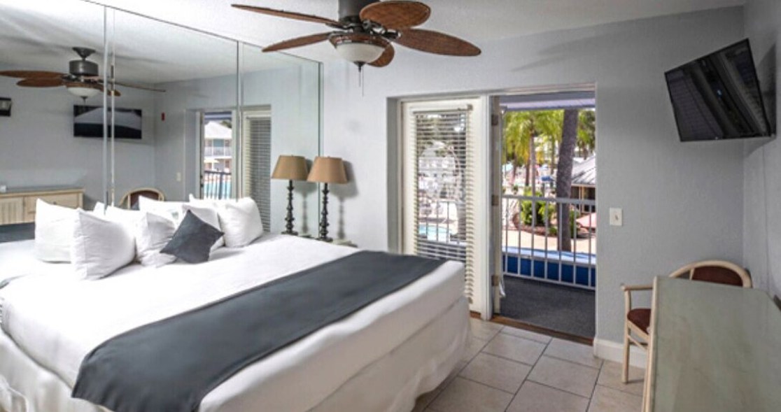 Guest room with a king bed and tropical decor