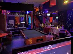 Club3X lounge with pool table and neon lighting in Cocoa, Florida