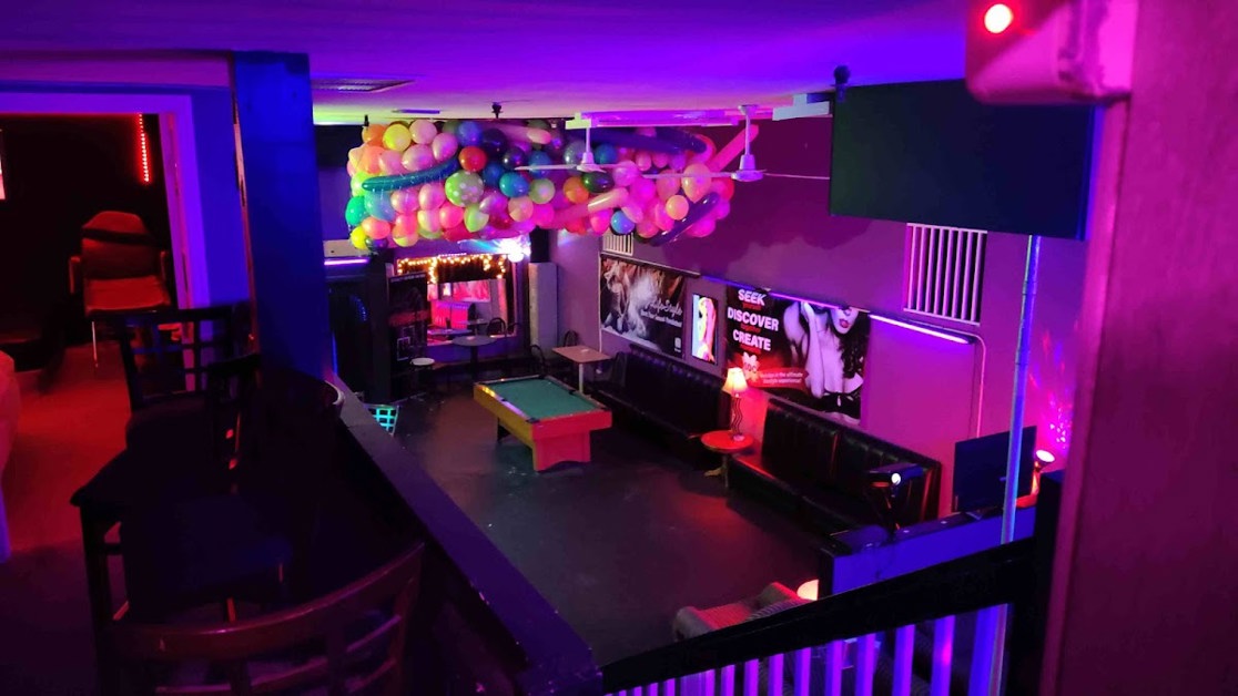 Neon-lit lounge interior with billiards table and seating