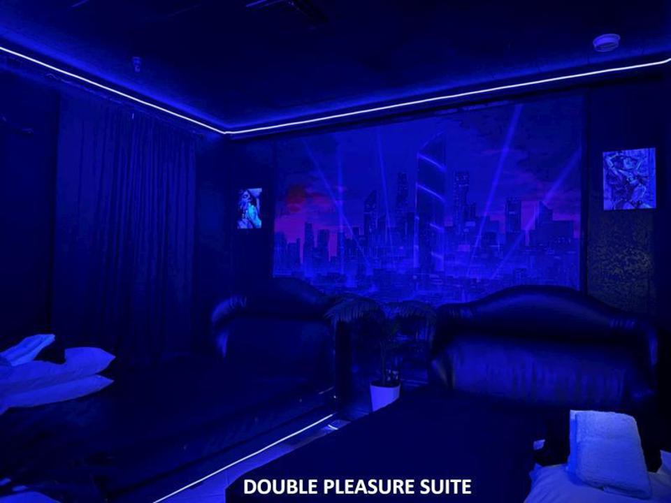 Eyz Wide Shut Double Pleasure Suite with blue lighting and lounge seating