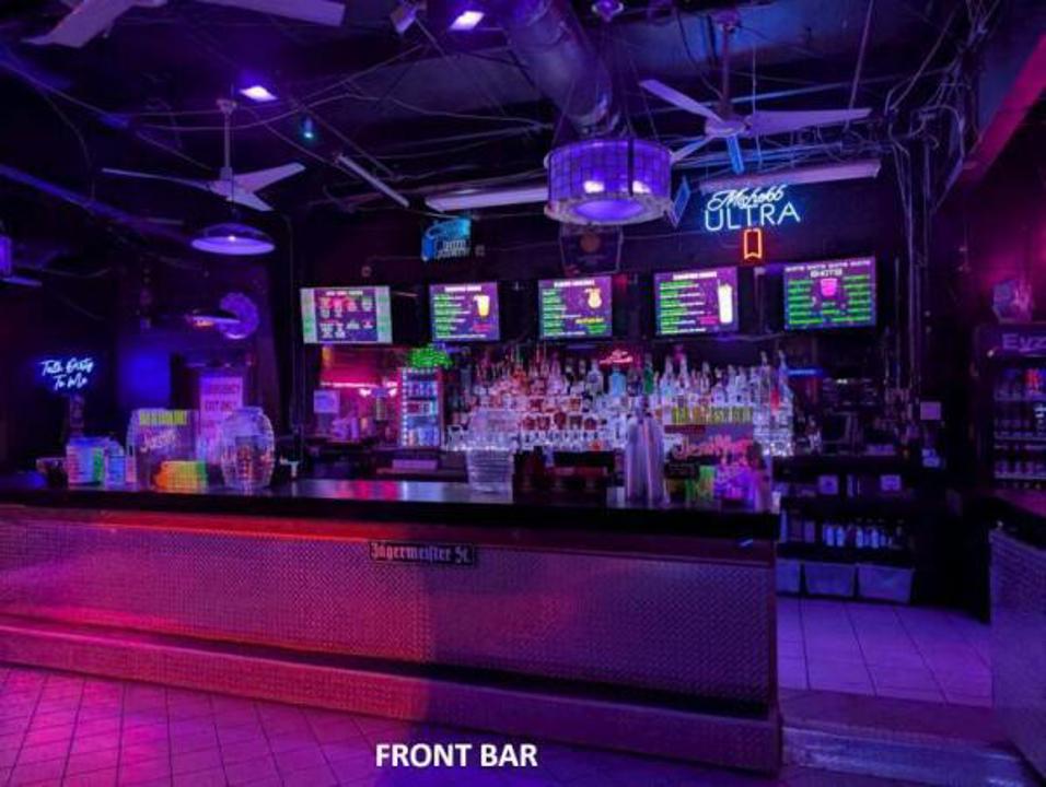 Eyz Wide Shut front bar with colorful lighting and liquor displays