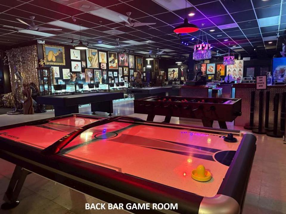 Back bar game room with air hockey and foosball tables