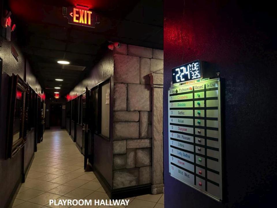 Playroom hallway with private room doors and status board
