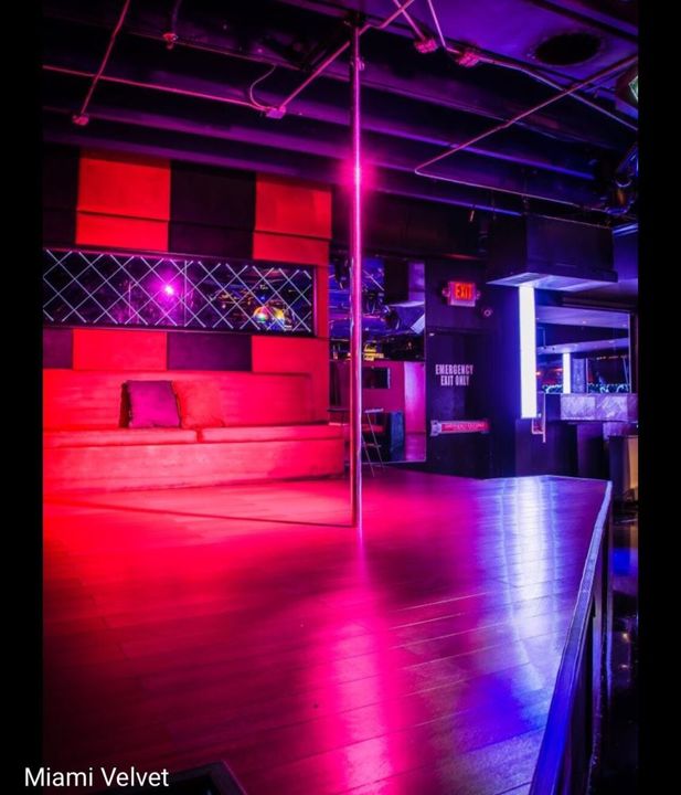 Dance stage with pole and red neon lighting