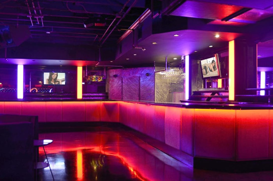 Neon-lit bar interior with illuminated counters