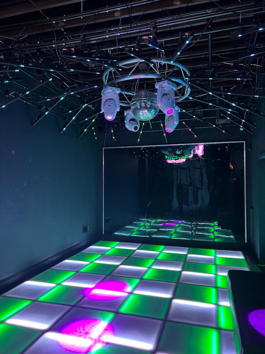 Illuminated dance floor with disco lighting