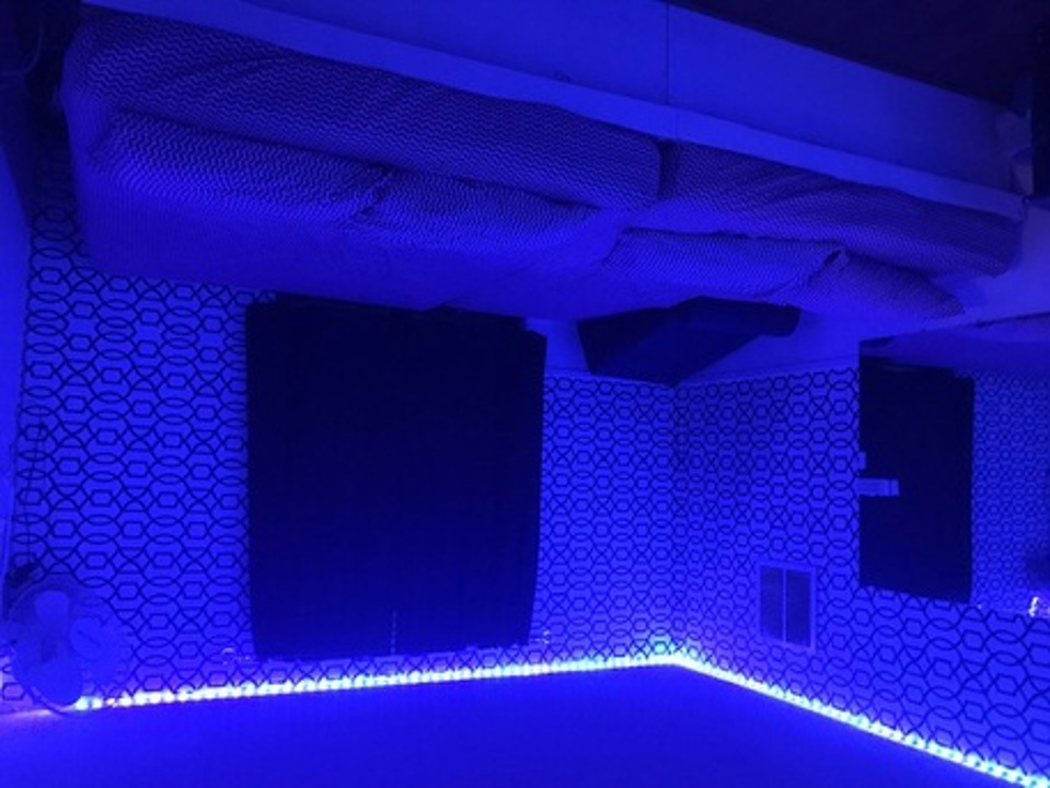 Blue-lit private playroom