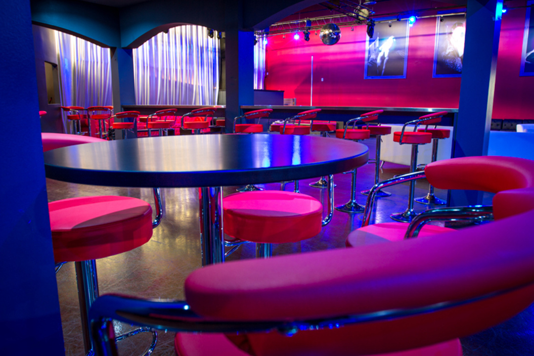 Red lounge seating under blue lighting