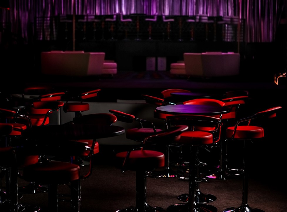 Red-lit tables and lounge seating