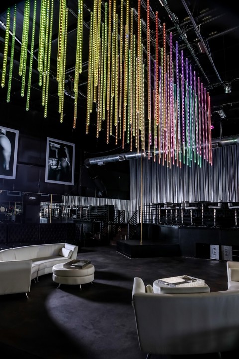 Lounge seating beneath colorful hanging lights