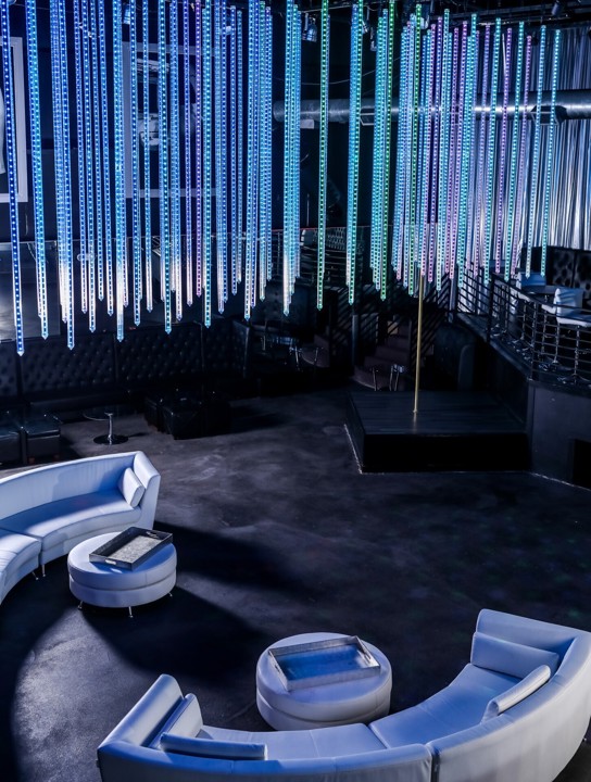 Curved lounge booth beneath decorative lighting