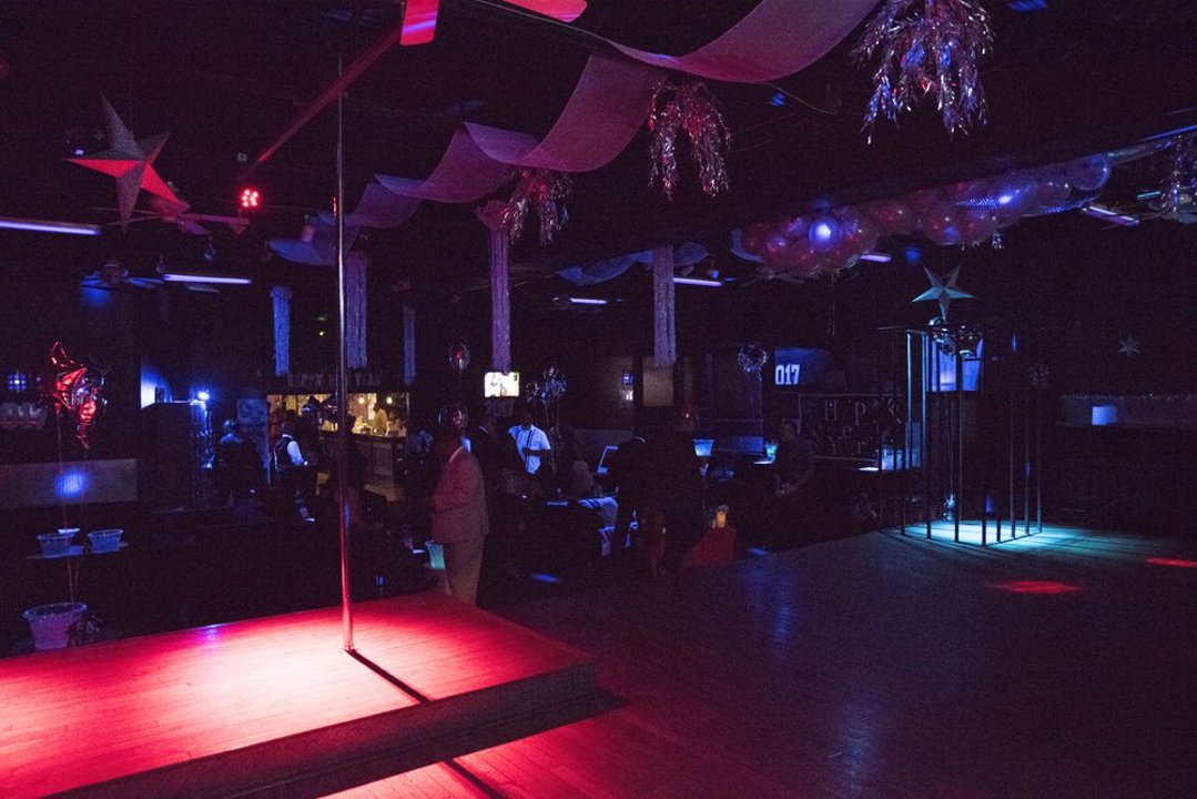 Floor with illuminated pole stage and dance cage
