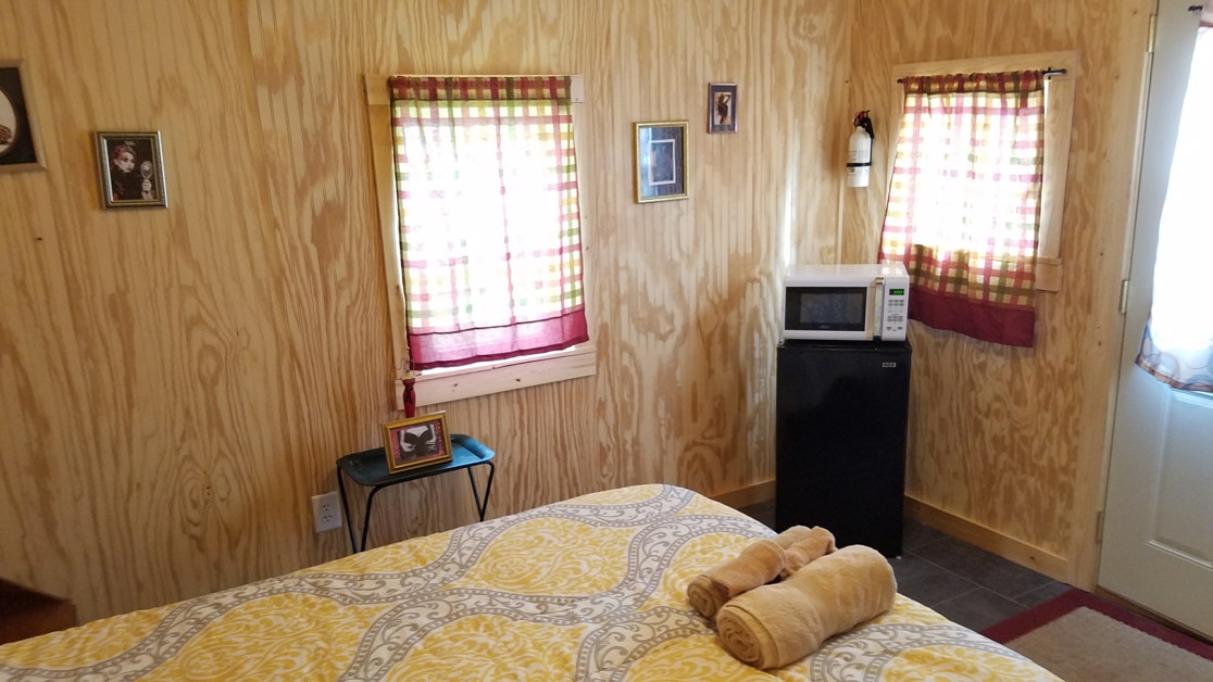 Cabin bedroom with refrigerator and microwave