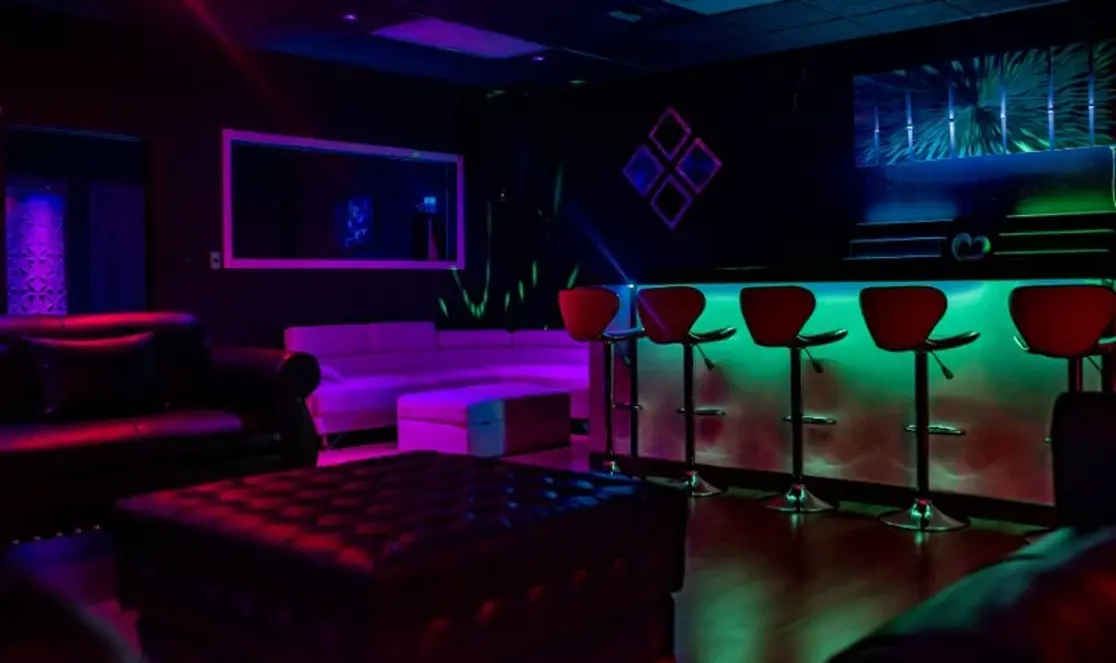 Neon-lit bar and lounge seating area