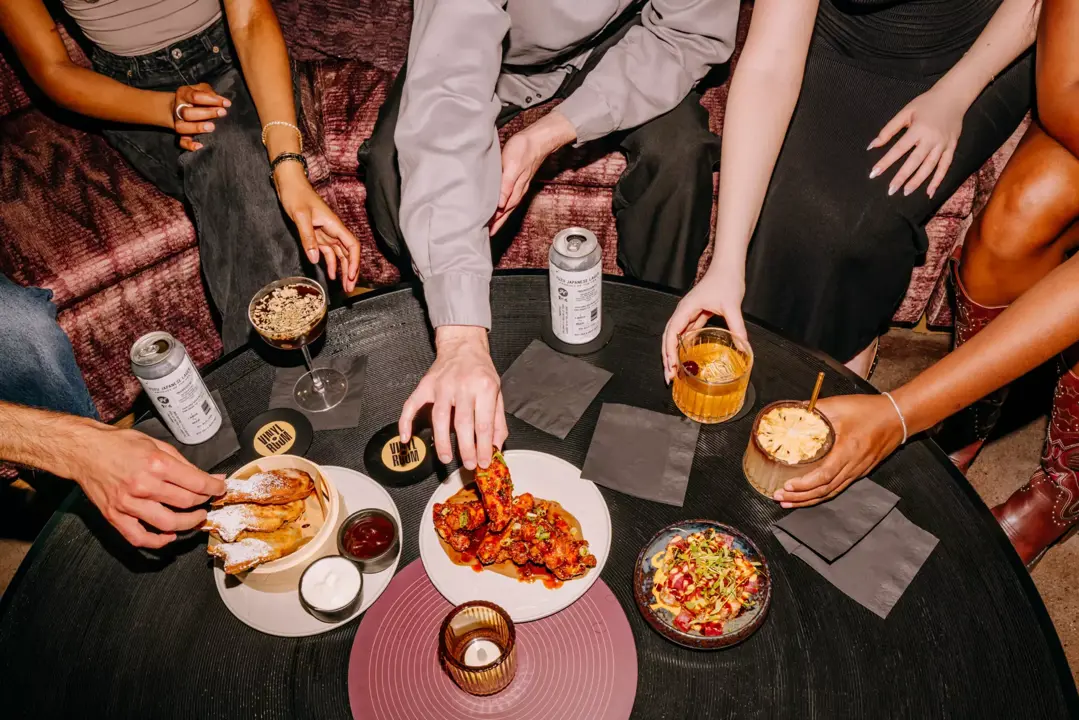 Guests socializing over drinks at Vinyl Room