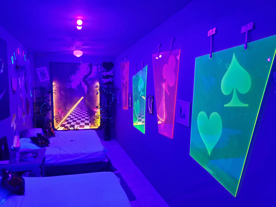 Rabbit Hole room with illuminated playing-card decor