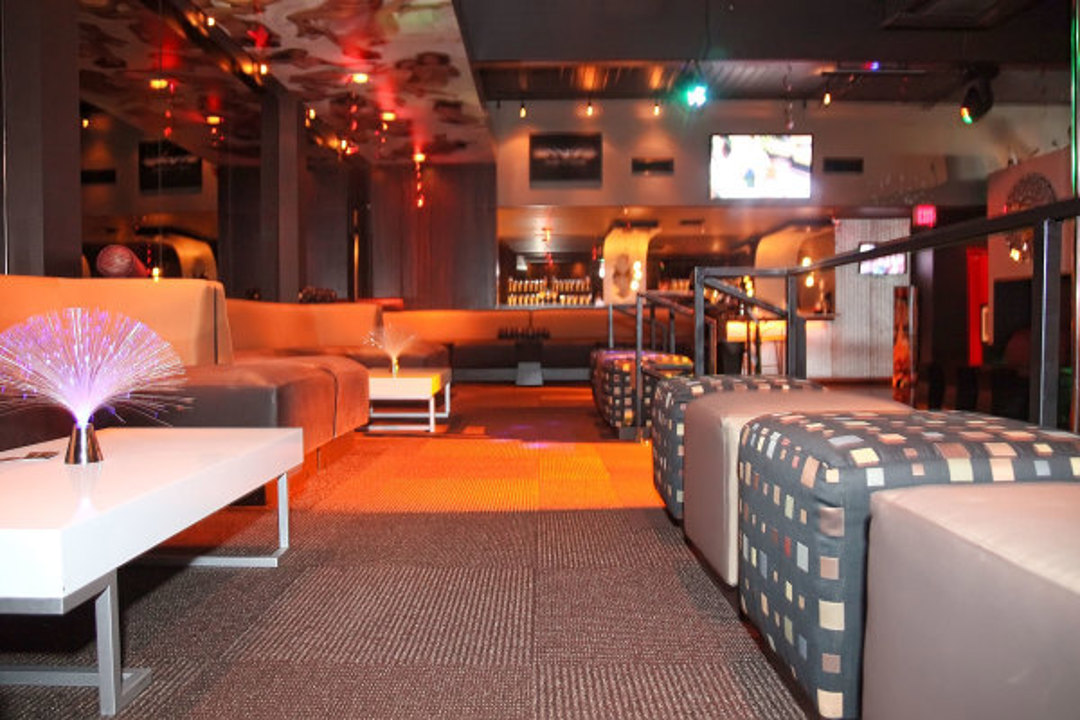 a club lounge with sofas and seating