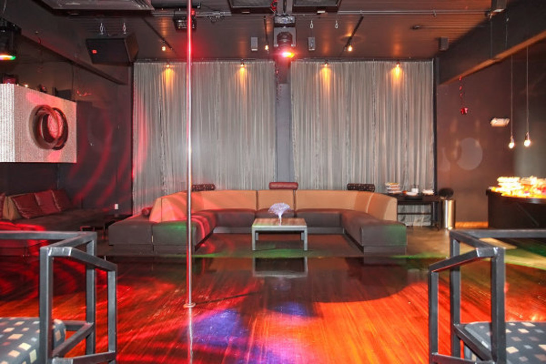 Dance floor and lounge under colorful club lighting