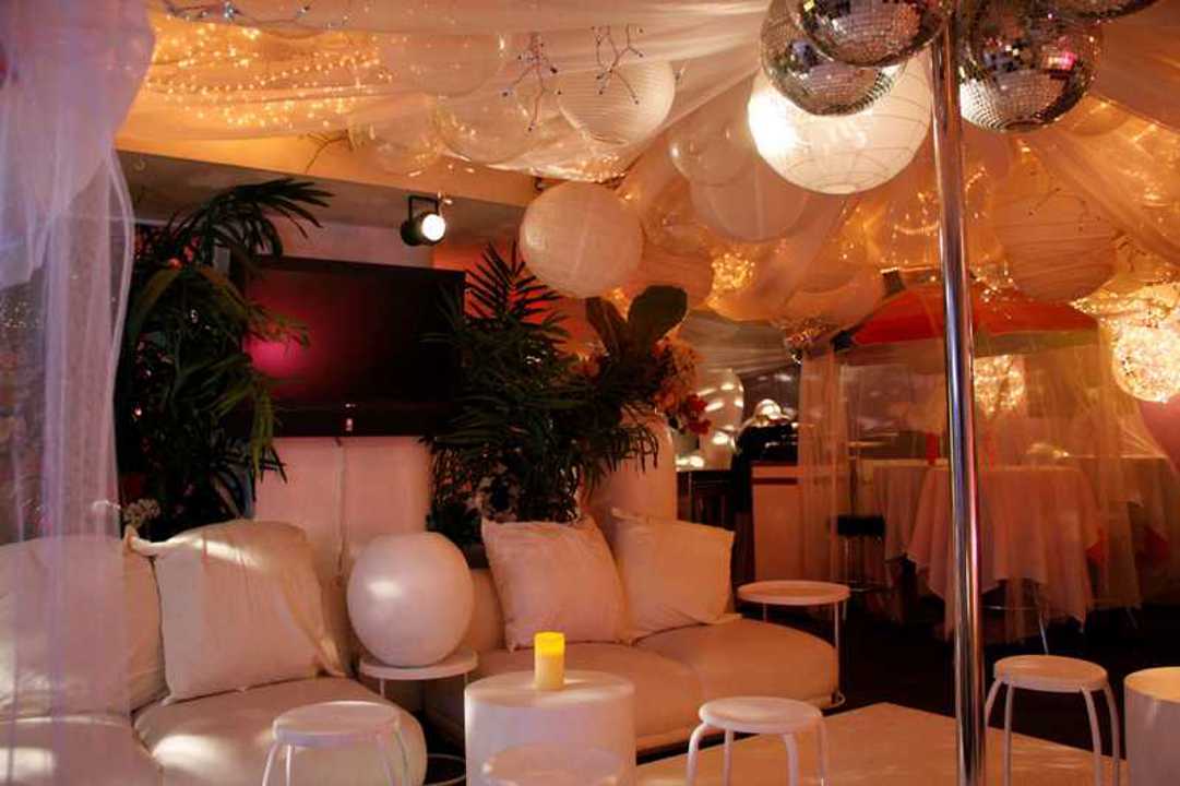 Lounge interior with white seating and disco balls