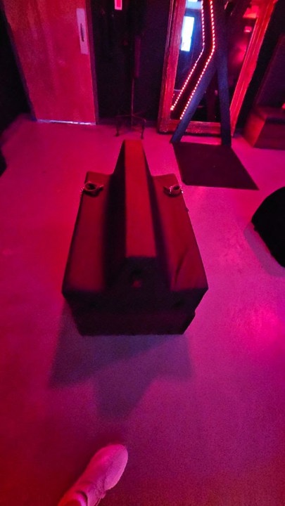 BDSM bench with restraint points and illuminated cross