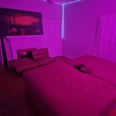 Odyssey Lounge purple-lit playroom with beds and lounge seating in Garner, North Carolina