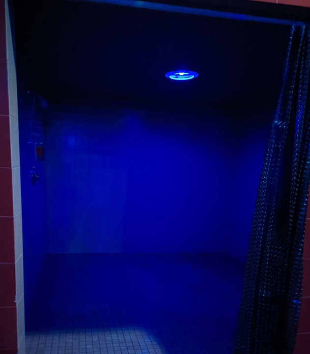 Blue-lit group shower area