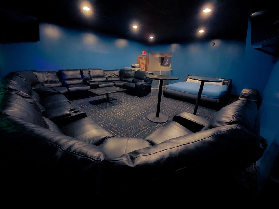 Private play lounge with sectional seating and bed